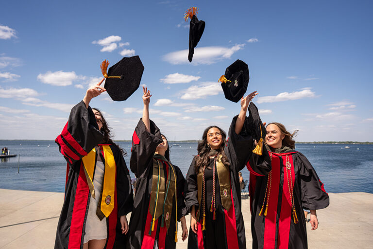 Graduates throwing their hats into the air