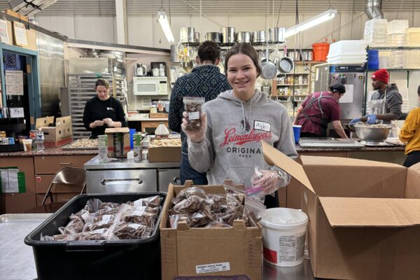 Abby Opsal helping pack food at The River Food Pantry.