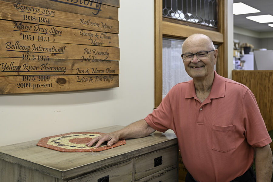 Jim Olson smiles in his family pharmacy