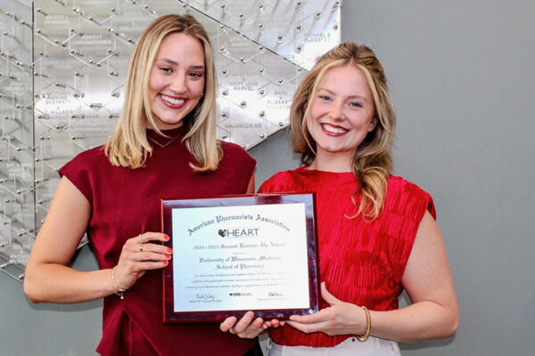 PharmD students Caitlin Cook and Alexis Huffman, 2024–25 Operation Heart co-chairs, with their APhA-ASP Second Runner-Up Award.
