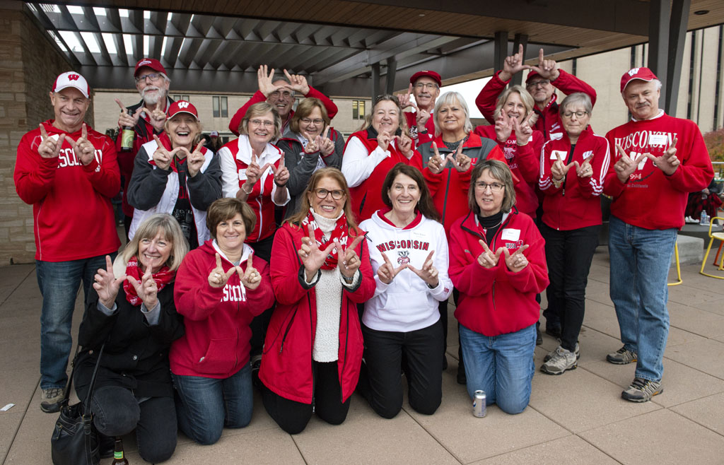 Classmates from the Class of 1978 throwing up the Wisconsin "W"