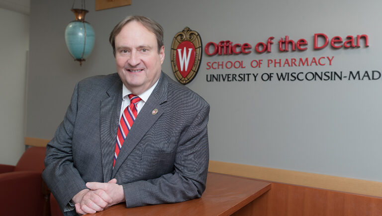 Portrait of Steve Swanson in front of an Office of the Dean sign