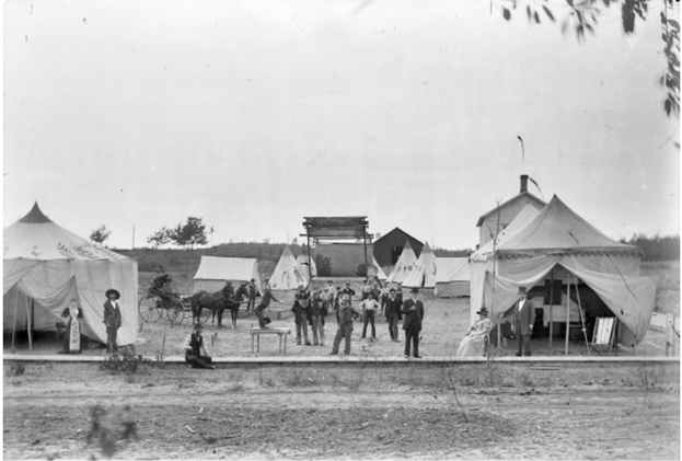 Black and white photo of a traveling medicine show