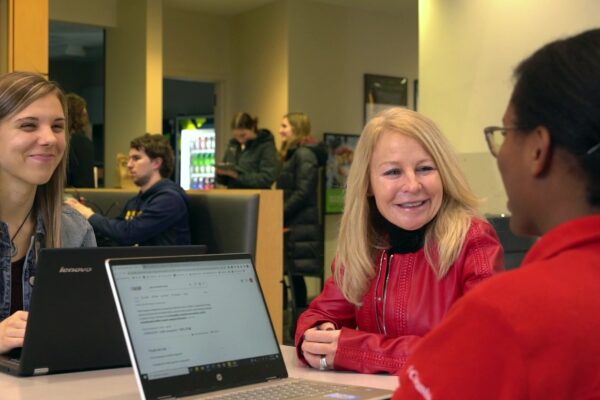 Nancy Gilbride speaks with two PharmD students