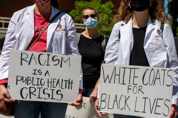 Racism is a Public Health Crisis, White Coats for Black Lives protest signs