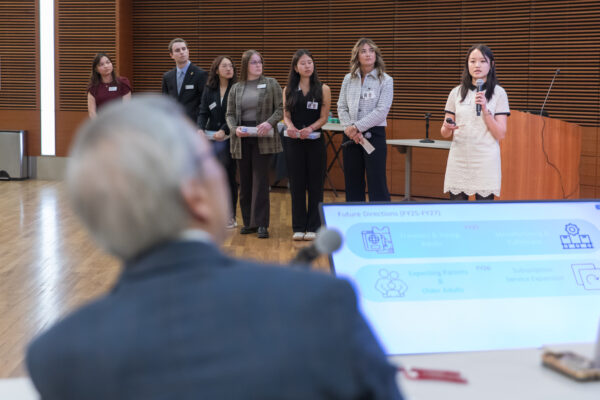 PharmD students present in front of Roger Tung
