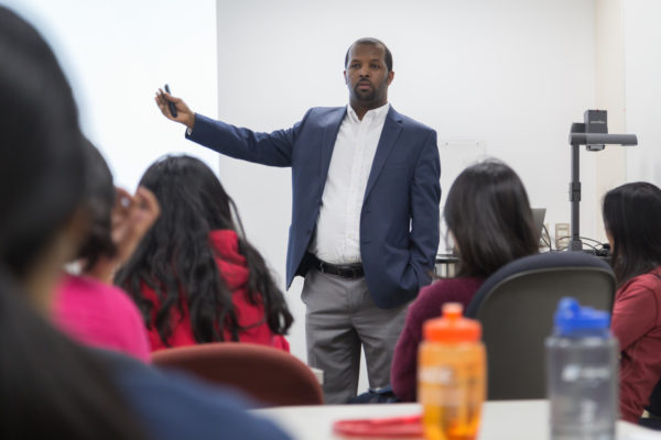 Ephrem Abebe speaking with students at the School of Pharmacy.