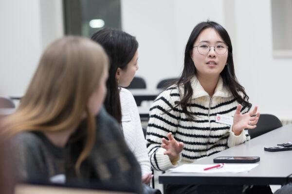 PharmD student Yoonsoo Kim speaks with peers during the DiveRxsity Dialogues event